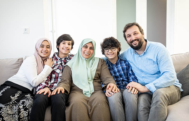 Happy,Muslim,Family,Portrait,On,Sofa